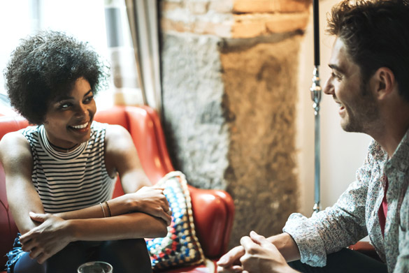 Beautiful couple looking at each other while sitting in cafe and talking - what is the sensual scorpio man looking for in a woman