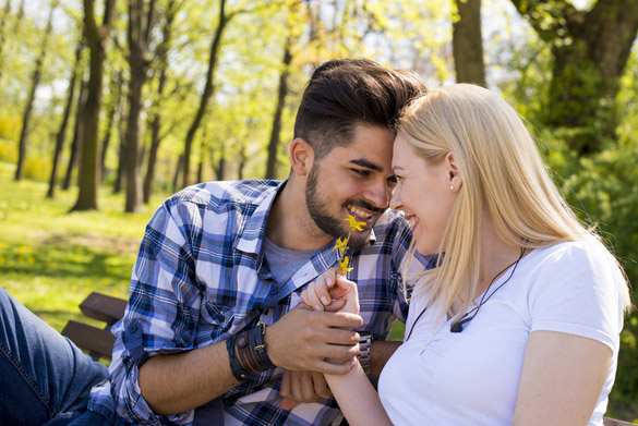 Beautiful loving couple flirting in the park on beautiful sunny day - Reasons Women find Scorpio Men So Irresistible