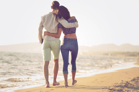 Couple walking on beach - What is it Like to Date a Scorpio Man