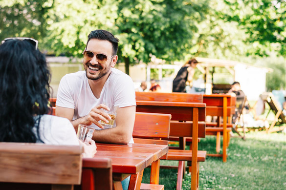 Dating couple talking and relaxing together in a street cafe - What is it Like to Date a Scorpio Man