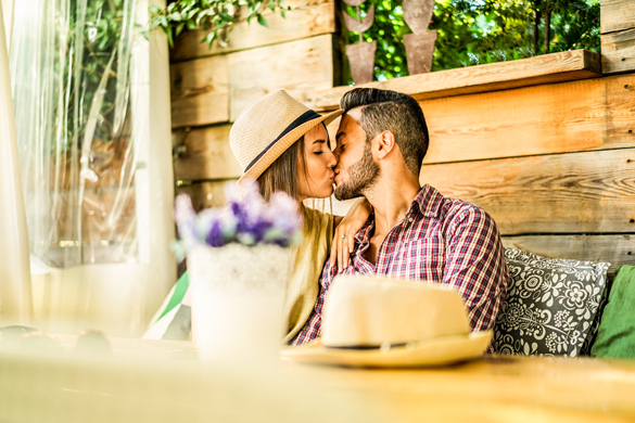 Happy travel couple having tender moments in bar restaurant - How To Keep A Scorpio Man Once You Get Him