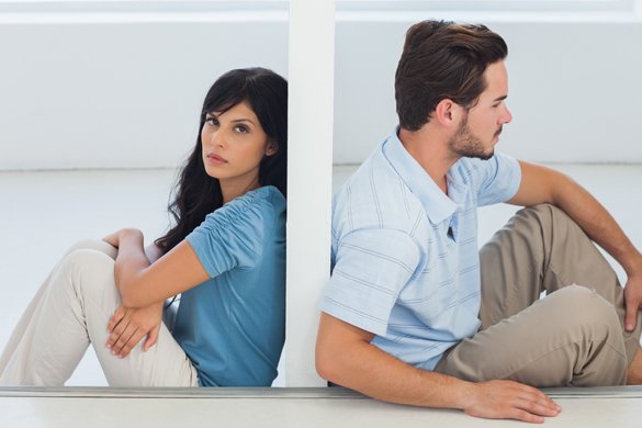 Sitting couple are separated by wall with woman looking at camera - Is It Possible To Get a Scorpio Man To Change His Mind