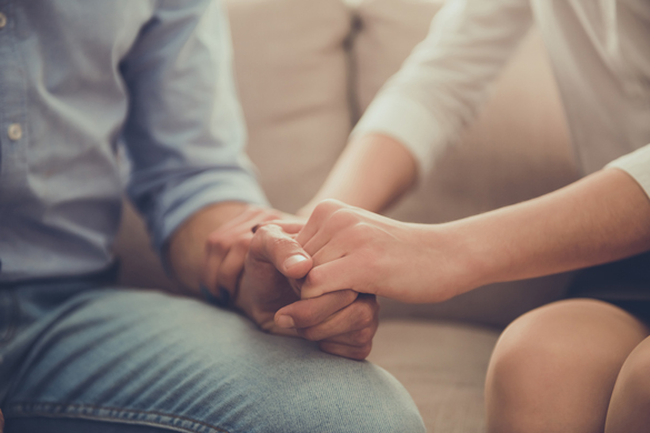 beautiful female psychologist holding her client's hands during the seance - When your Scorpio Man is Upset but Won’t Tell You Why